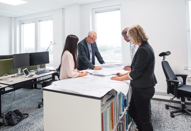 Architects discussing blueprint in office